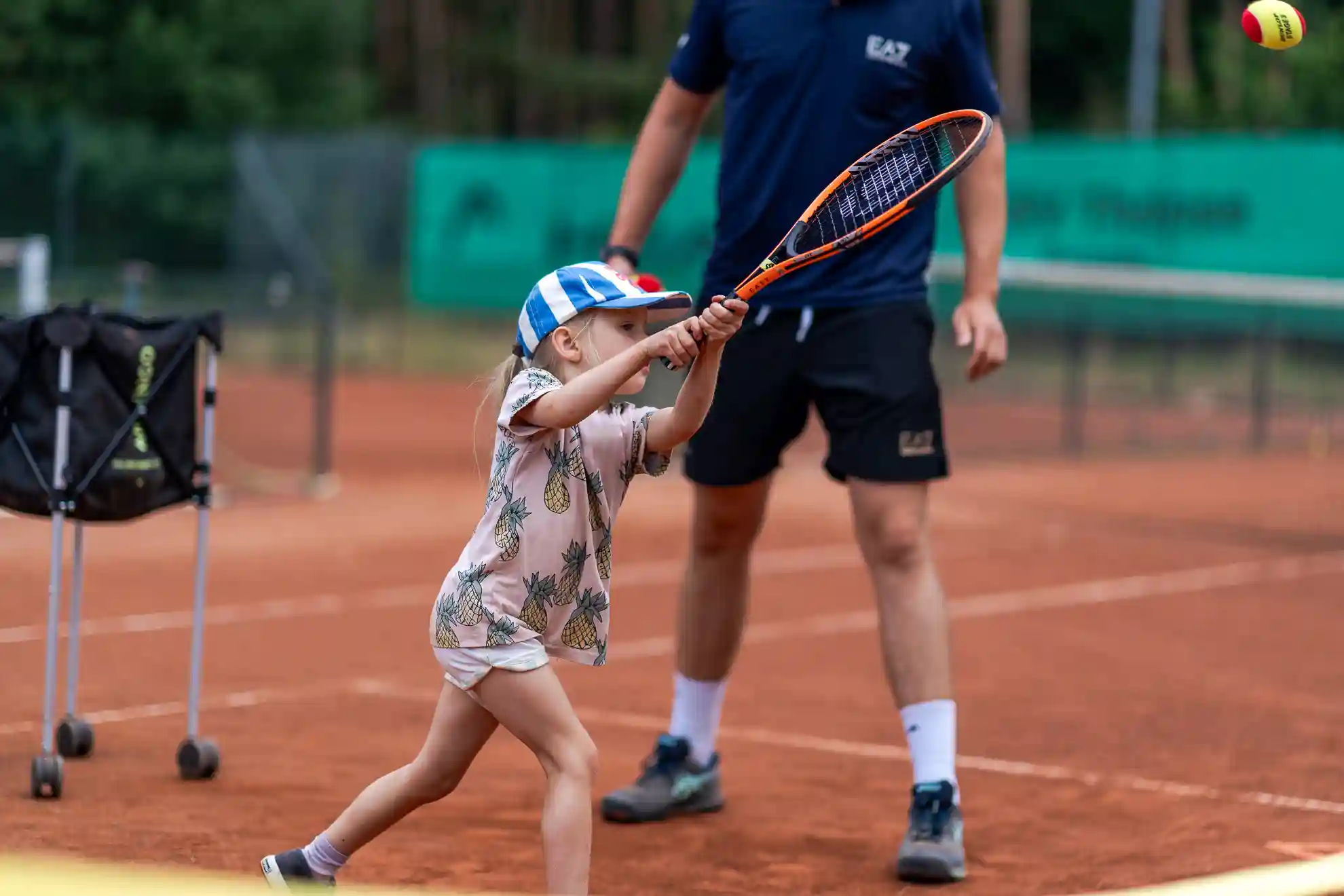 Mädchen schlägt einen Tennisball..